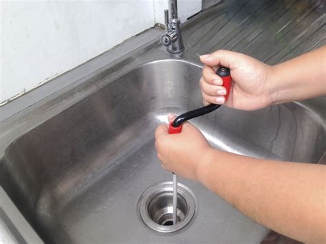 How to Snake a Kitchen Sink with Garbage Disposal: A Guide to Unclogging Your Drain and Pondering the Mysteries of Plumbing